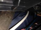 the_cable_trunk_under_rear_drivers_seat_area,_using_huge_pry_bar_to_lift_from_the_rear_door_entry_sill_for_access.jpg